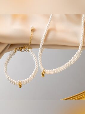 Elegant White Pearl Necklace and Bracelet Set with Gold Accents